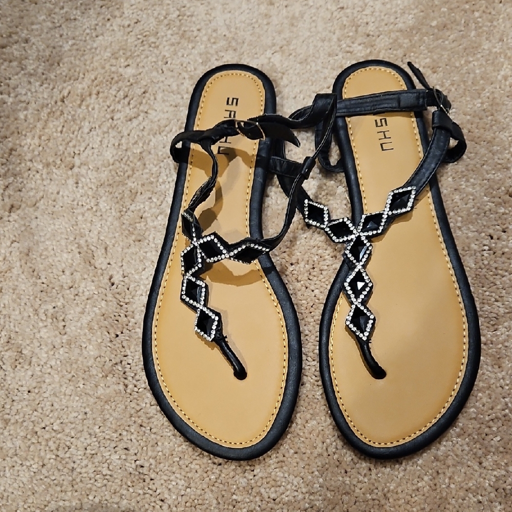 Black and Tan T-Strap Sandals with Metallic Embellishments